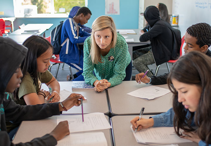 A Summit teacher working with a group of four students